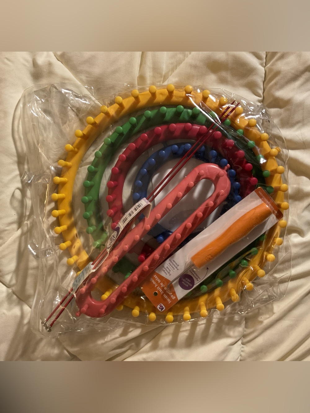 Colorful Round Loom for knitting with some knitting hooks.